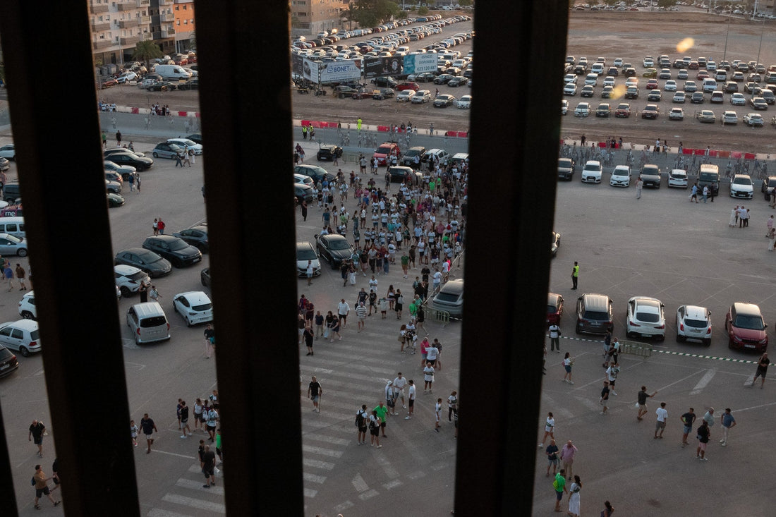 Aerial view of fans walking across a stadium car park
