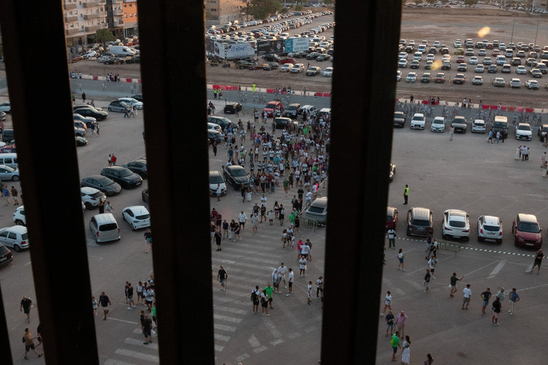 Aerial view of fans walking across a stadium car park