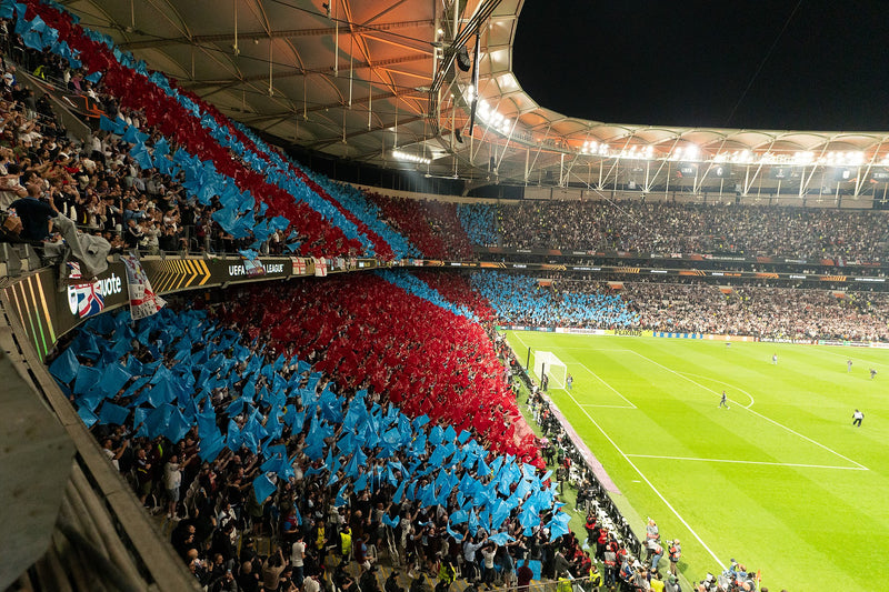 Aston Villa fans form a claret and blue tifo across the stand on a European night