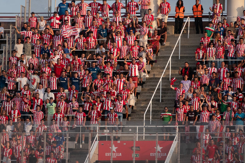 Athletic Club fans in red and white shirts packed into the stand
