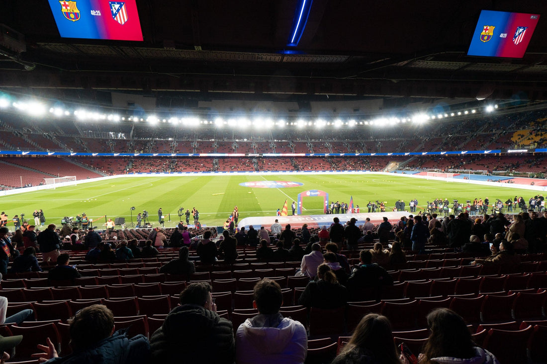 Camp Nou seen from the lower stand under the floodlights