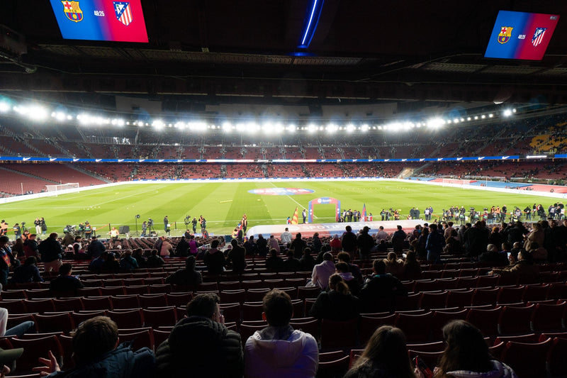 Camp Nou seen from the lower stand under the floodlights