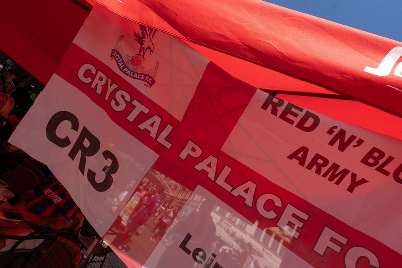 Crystal Palace Red 'n' Blue Army banner hanging under a red awning