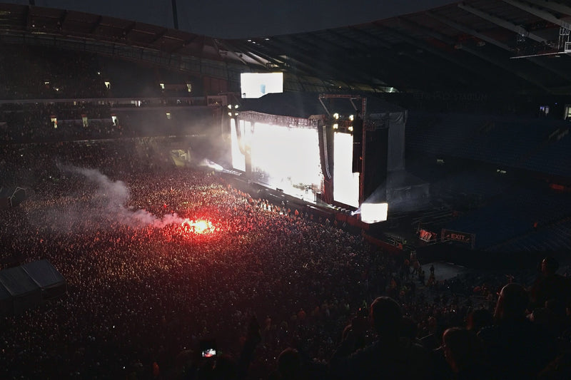 Dark night view from an upper tier of a stadium during a concert