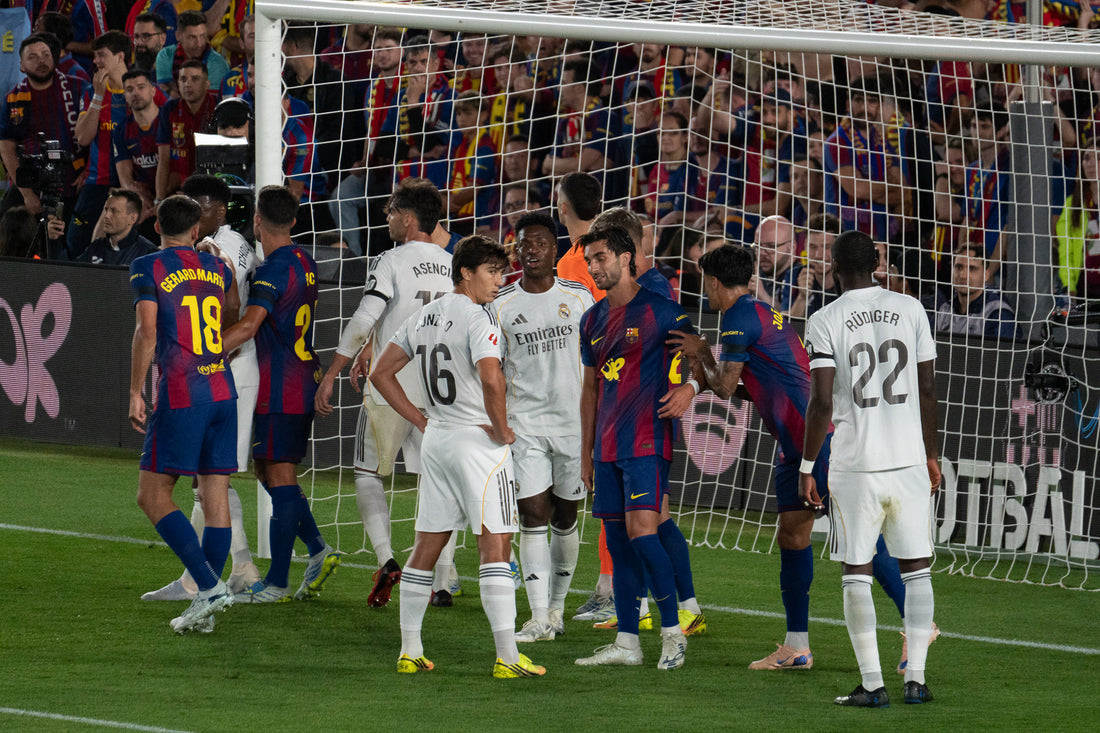 Barcelona and Real Madrid players jostle in the box before a corner during El Clasico