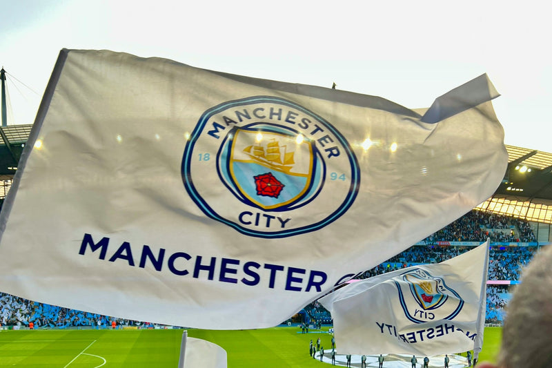 Manchester City flag waved by a supporter inside the Etihad Stadium