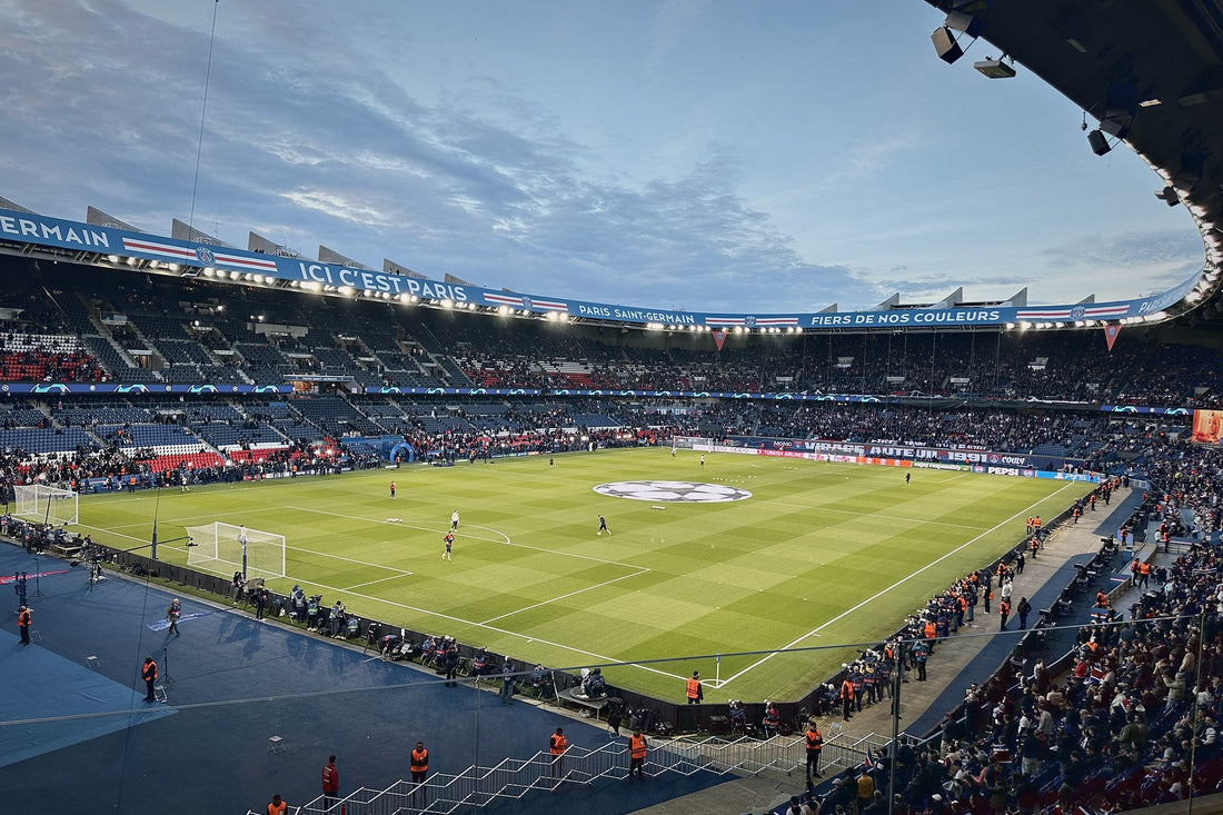 Parc des Princes at dusk with the Ici c'est Paris banner along the roof