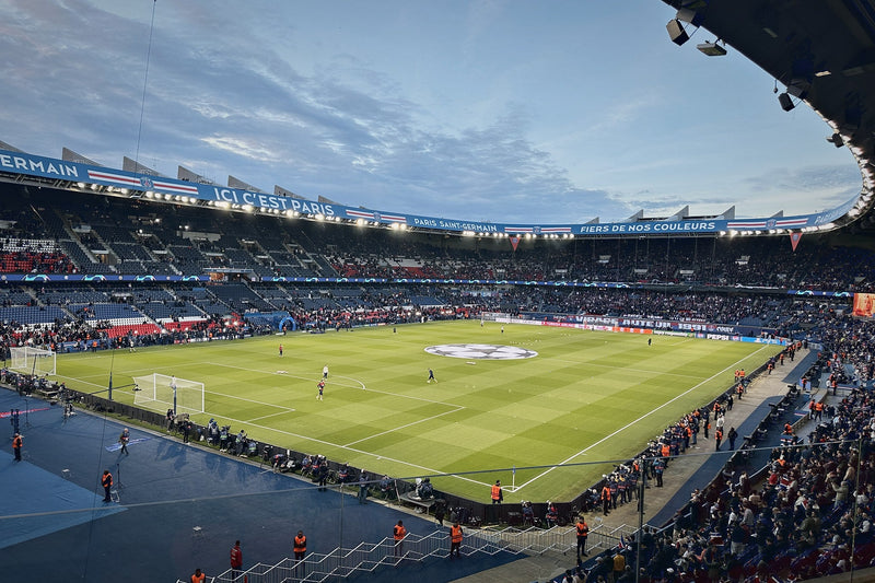 Parc des Princes at dusk with the Ici c'est Paris banner along the roof