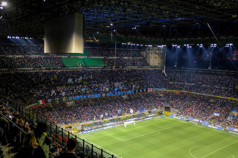 Packed San Siro at night seen from the upper tier