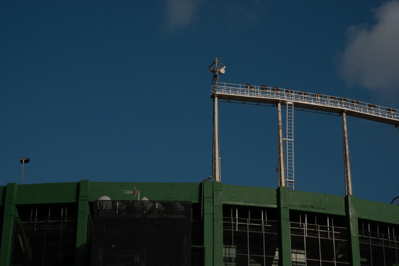 Stadium floodlight gantry against a deep blue sky